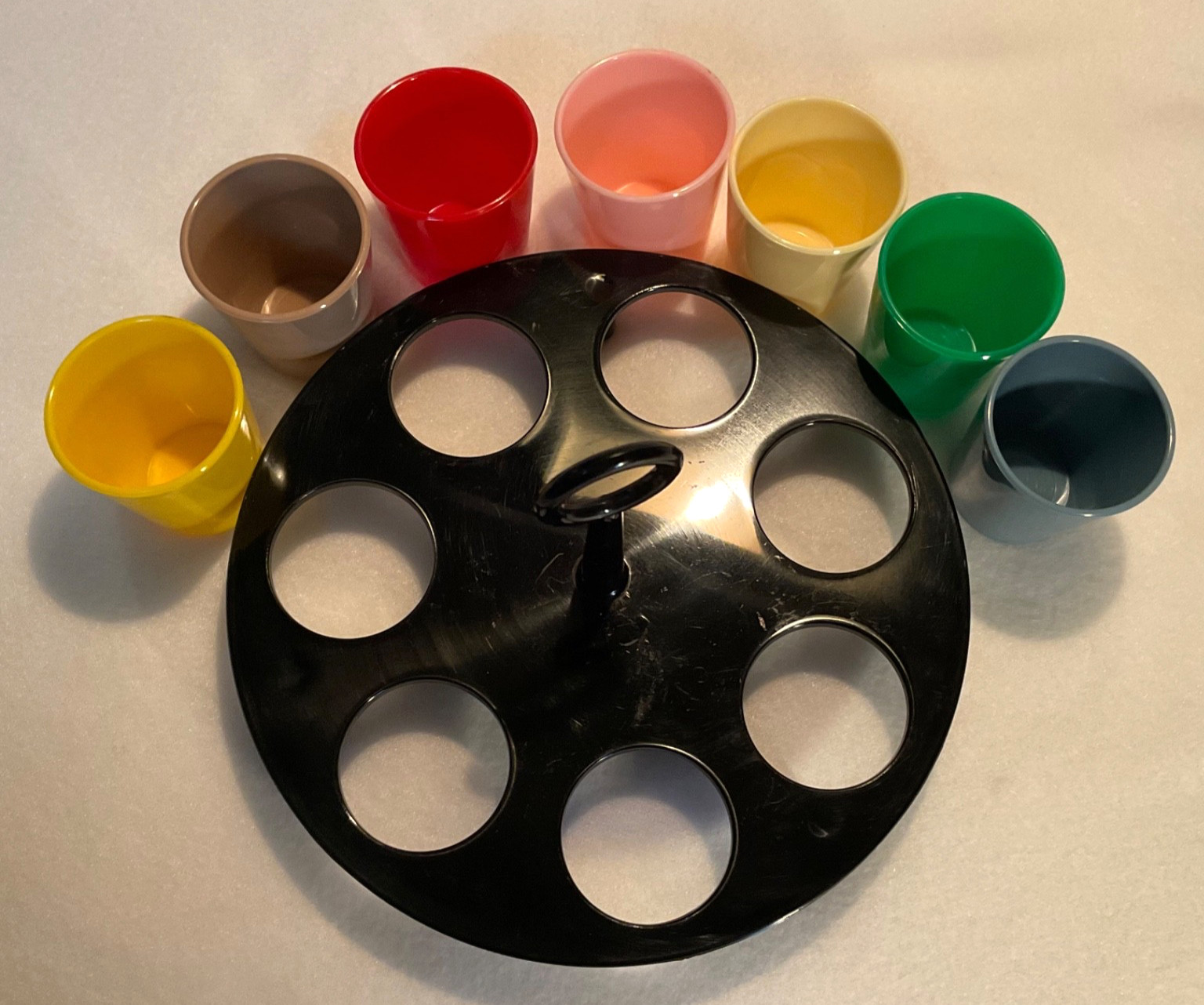 7 Plastic Multicolored Shot Glasses w/Black Carrier/Caddy. RARE SERVall Products