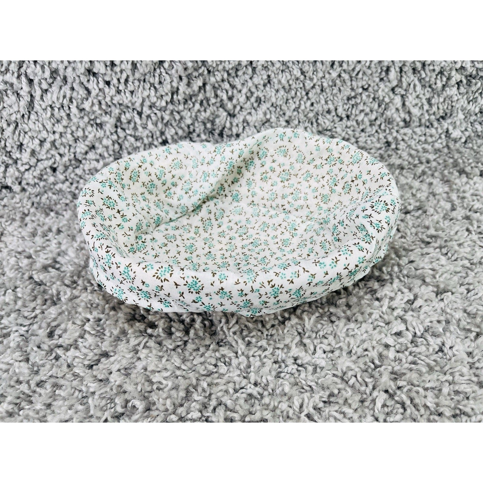 Small Wicker Basket With a Removable Cloth Liner Featuring a Teal Floral Pattern