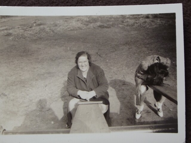 WOMAN AT BOTTOM OF A SEE SAW WITH CAMERA PERSON UP TOP 1930’s PHOTO