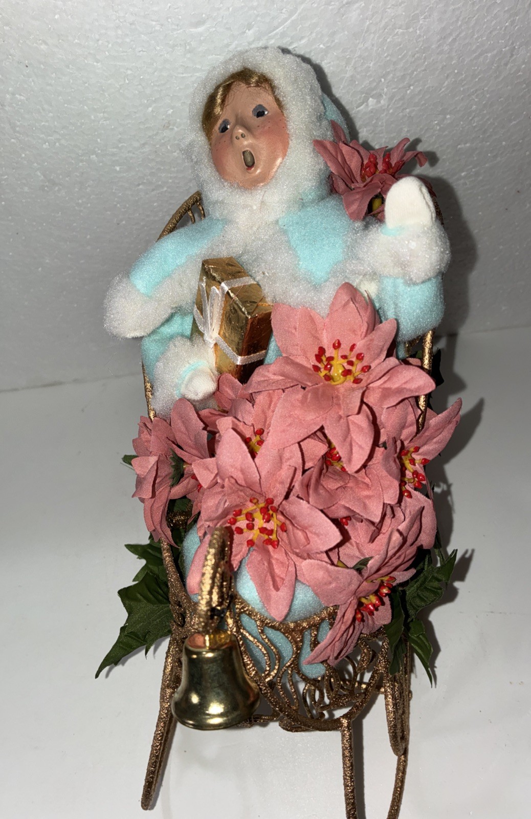Buyers Choice Singing Girl in Sleigh with Gift, Bell And Poinsettias, 10.5” X 9”