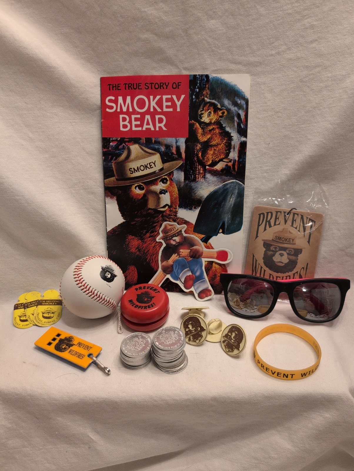 Lot of Smokey the Bear Memorbilia-baseball, Glasses, Yoyo,Book, Coins, Badges…
