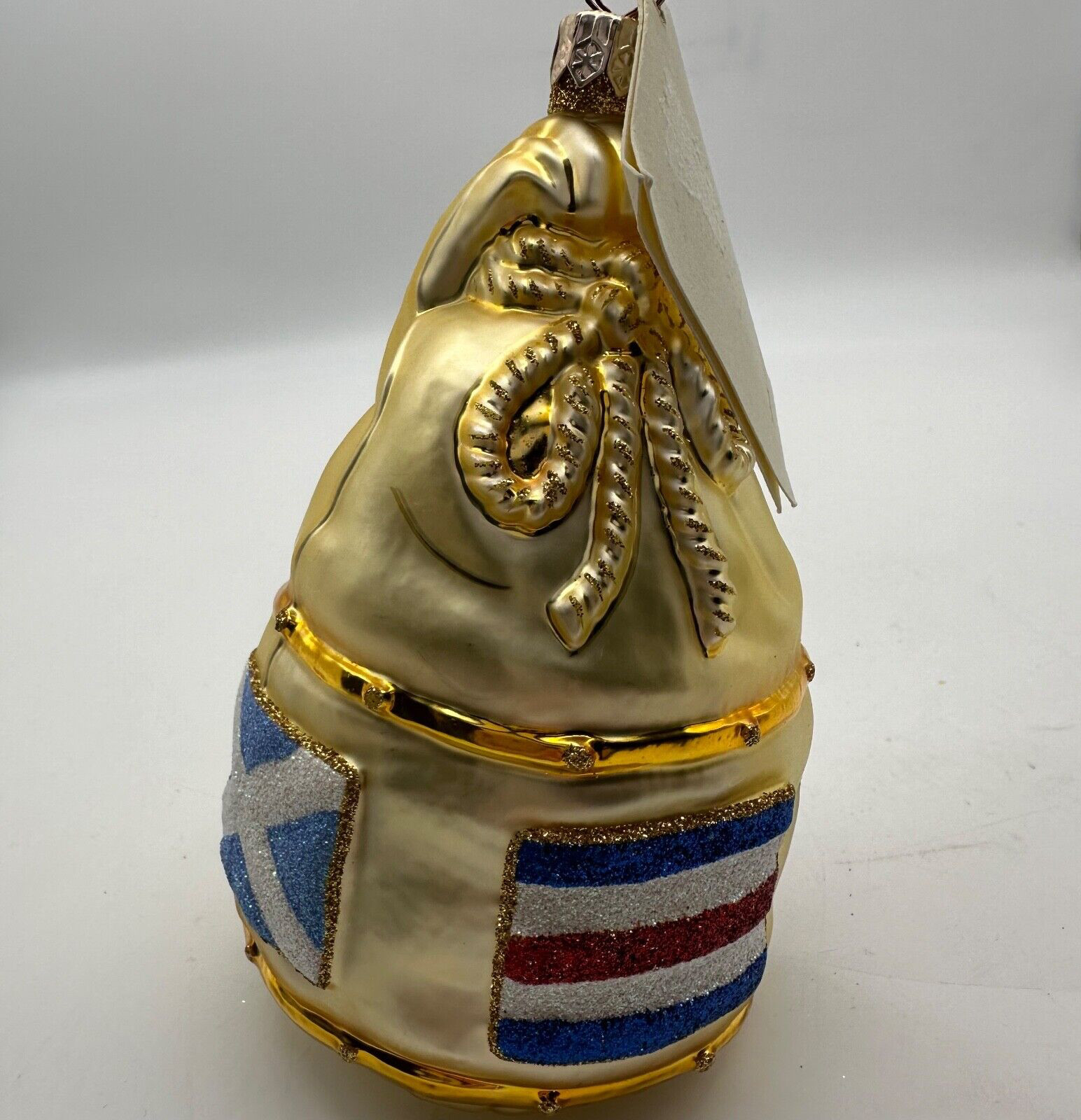 2000 Particia Breen Santa’s Duffel Gold 3.54″ Ornament witg Flags