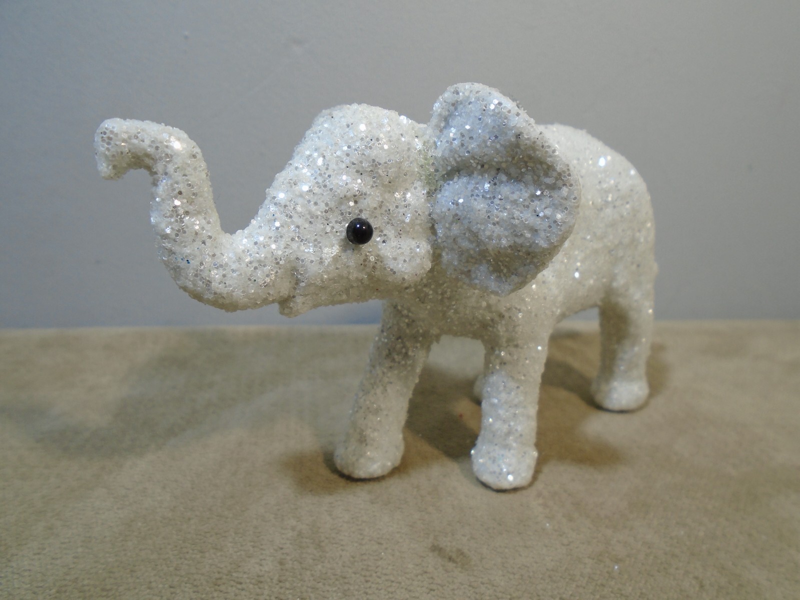 SILVER GLITTERED PLASTIC BABY ELEPHANT 2.5” X 5” ORNAMENT UNBRANDED (CB2507)