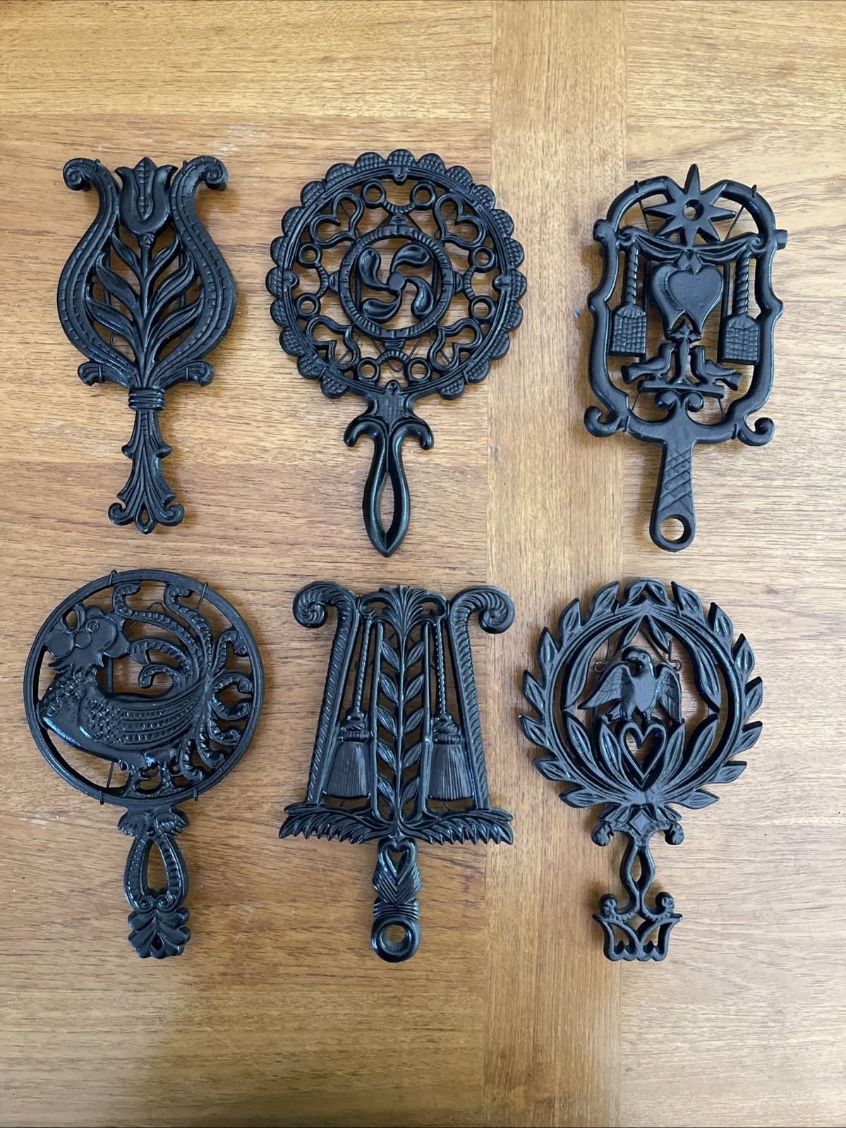 Lot 6 Vintage & Antique Cast Iron Trivets Between 8”-9” Long.