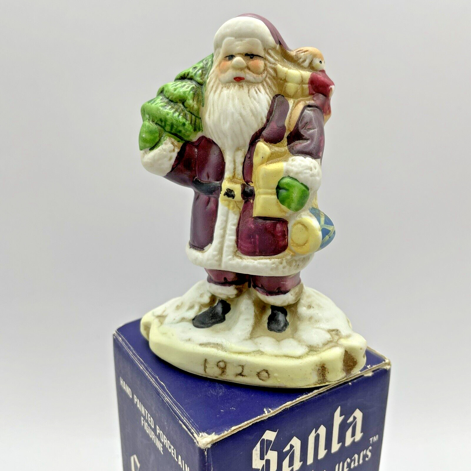 Santa Through the Years 1920 THE CONTEMPORARY Saint Nick in Box 1990 Deep Red