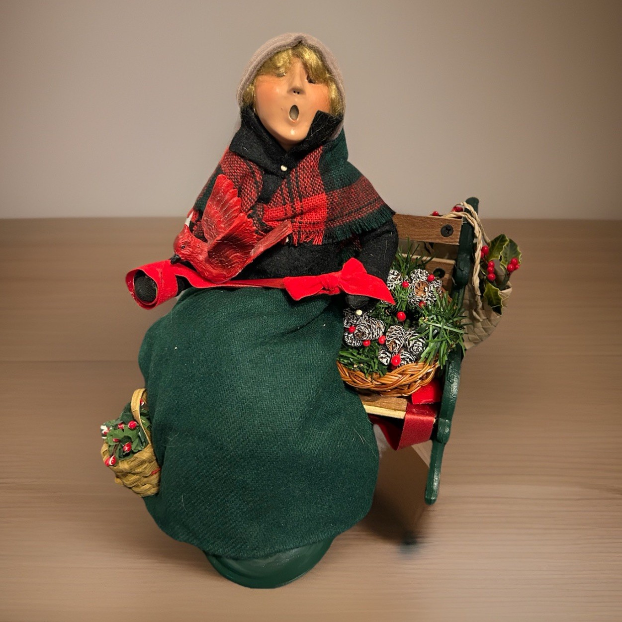 Byers’ Choice Winterthur Woman w/ Wreath, Greens, Cardinal Sitting on Bench 2002
