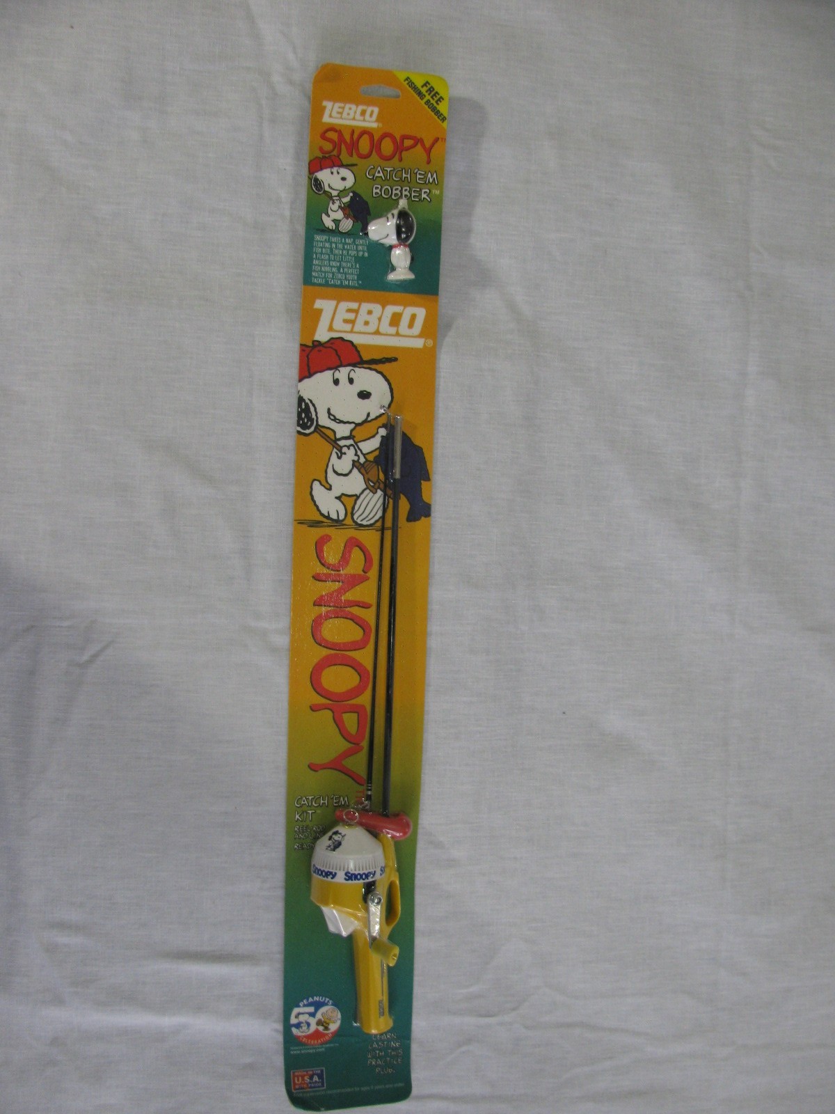NIP Vtg Zebco Snoopy Catch ‘Em Kit 40″ 2 pc Fishing Pole/Bobber,50th Anniv,1999