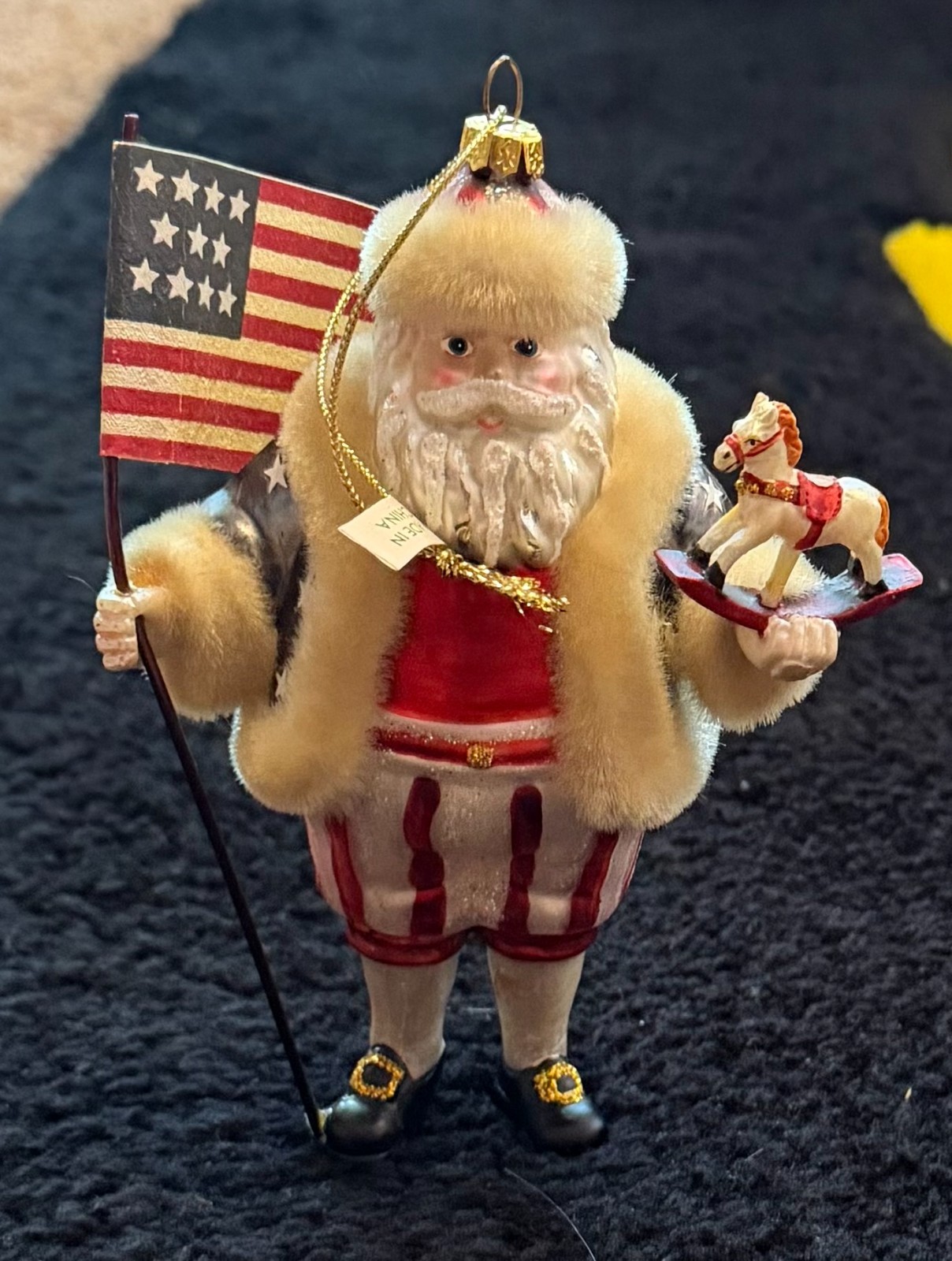 Patriotic Jolly Santa Christmas Ornament with a US Flag & Holding Rocking Horse