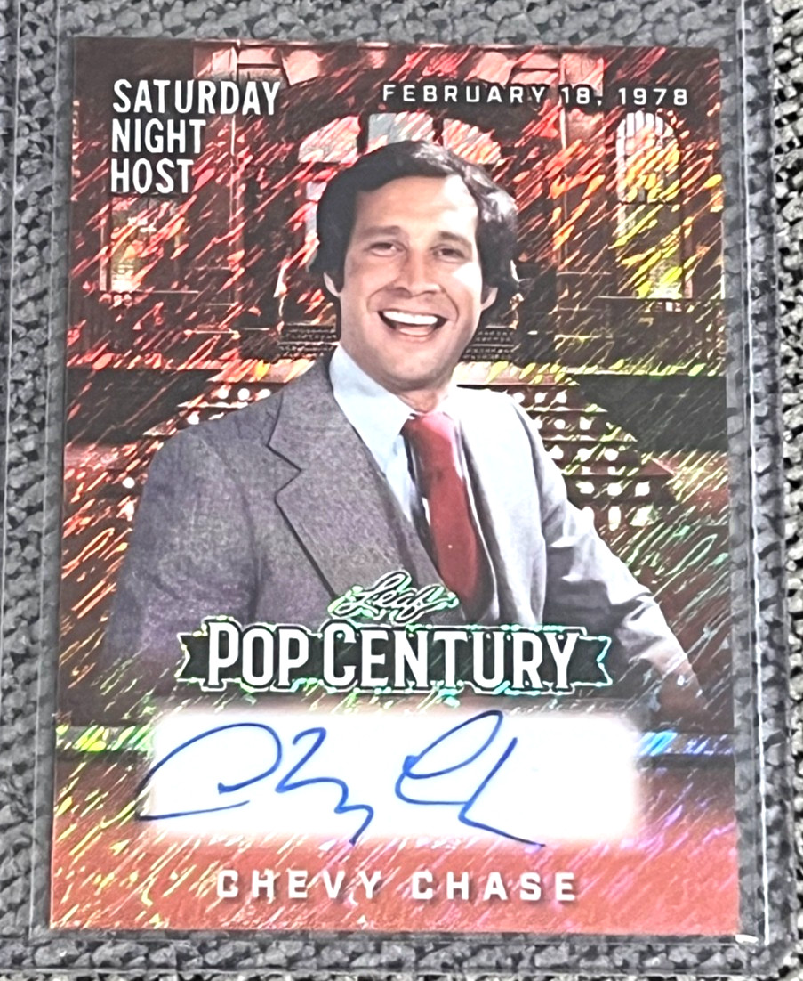 2025 Leaf Pop Century Chevy Chase SATURDAY NIGHT HOST Orange Shimmer Auto #1/4