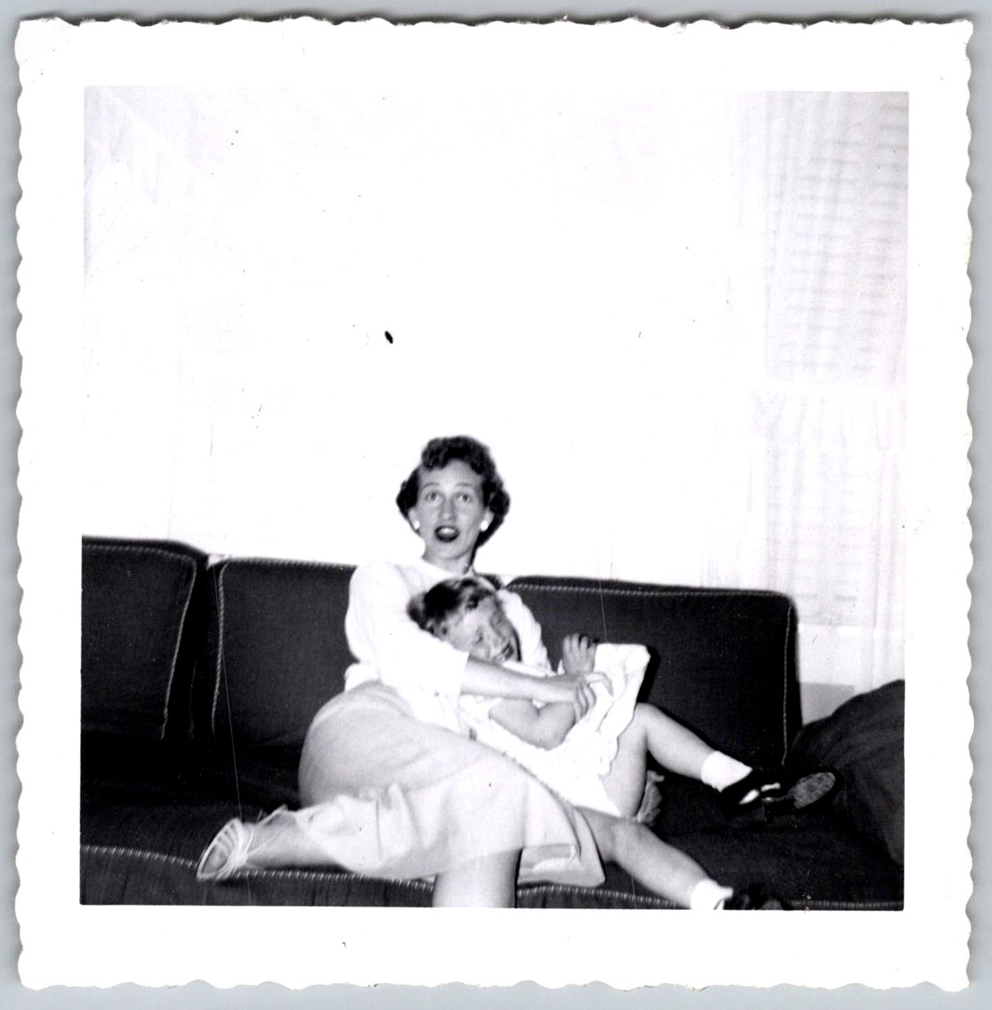 Vtg B&W Snapshot Candid Woman Holding Laughing Young Girl On Couch Indoors 1950s