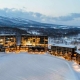 Park Hyatt Niseko Hotel illuminated with lights and blanketed in snow during the winter season.